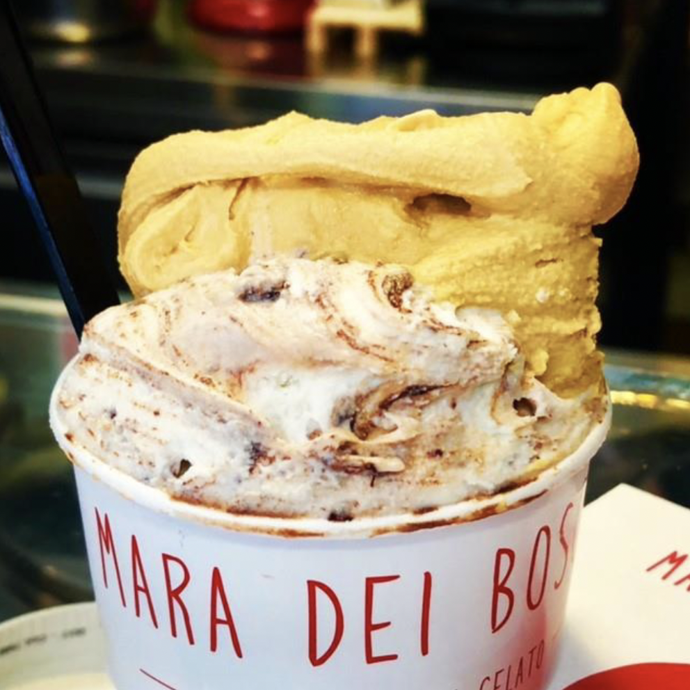 Two scoops of Italian gelato are in a cup, ready to eat